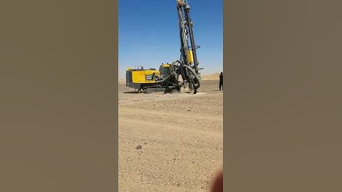 Drilling Blasting Holes with Atlas Copco Flexiroc D65.  Gold Mining in Sudan..