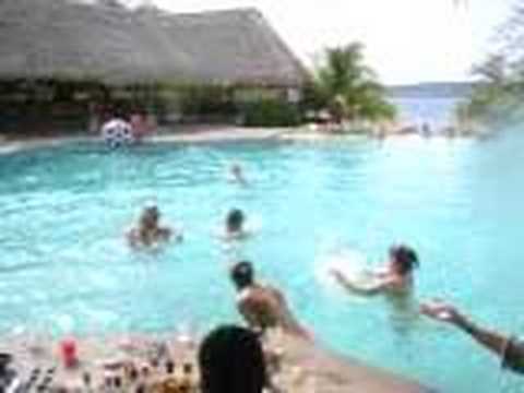 Synchronized tequila shots at poolside bar in Cost...