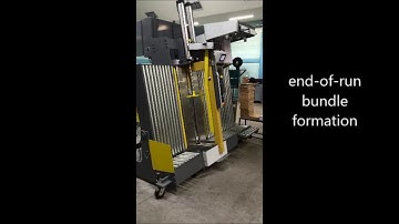 Model 195 Vertical Log Stacker with Post press delivery converging system  Goss Magnum Compact with