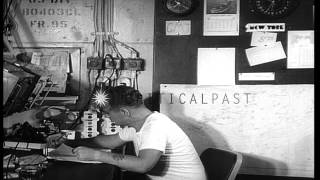 Men work on typewriters in a cabin of USS Mount McKinley AGC-7 underway in the Pa...HD Stock Footage