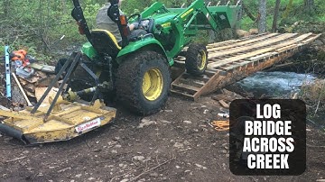 Building Log Bridge Across Rushing Creek