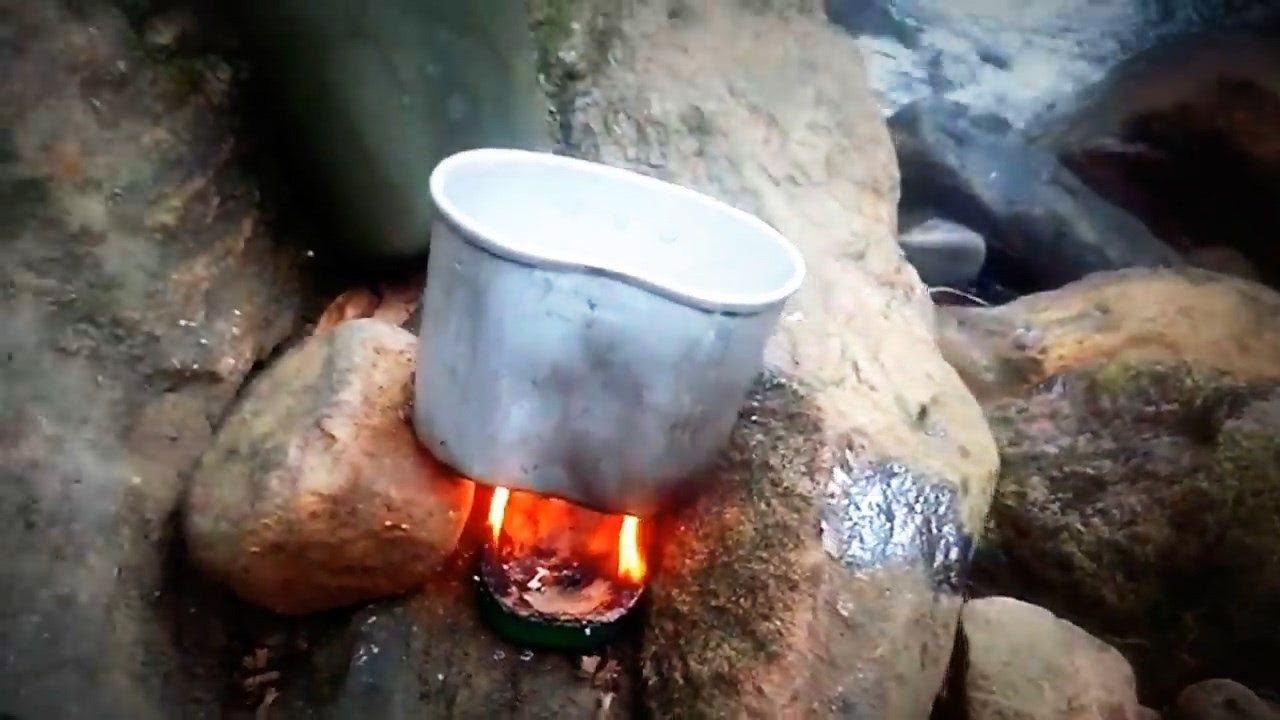 Bushcraft Cooking Pasta with tomato sauce and sardines in sardine tin
