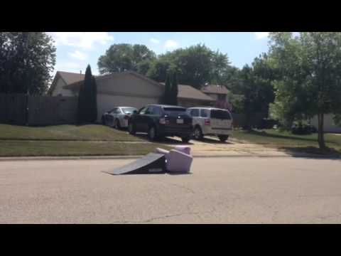 Chuck Aimaro skating over couch