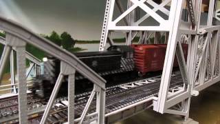 Bachman Santa Fe Alco S 4 pulling a short train through the lift bridge.
