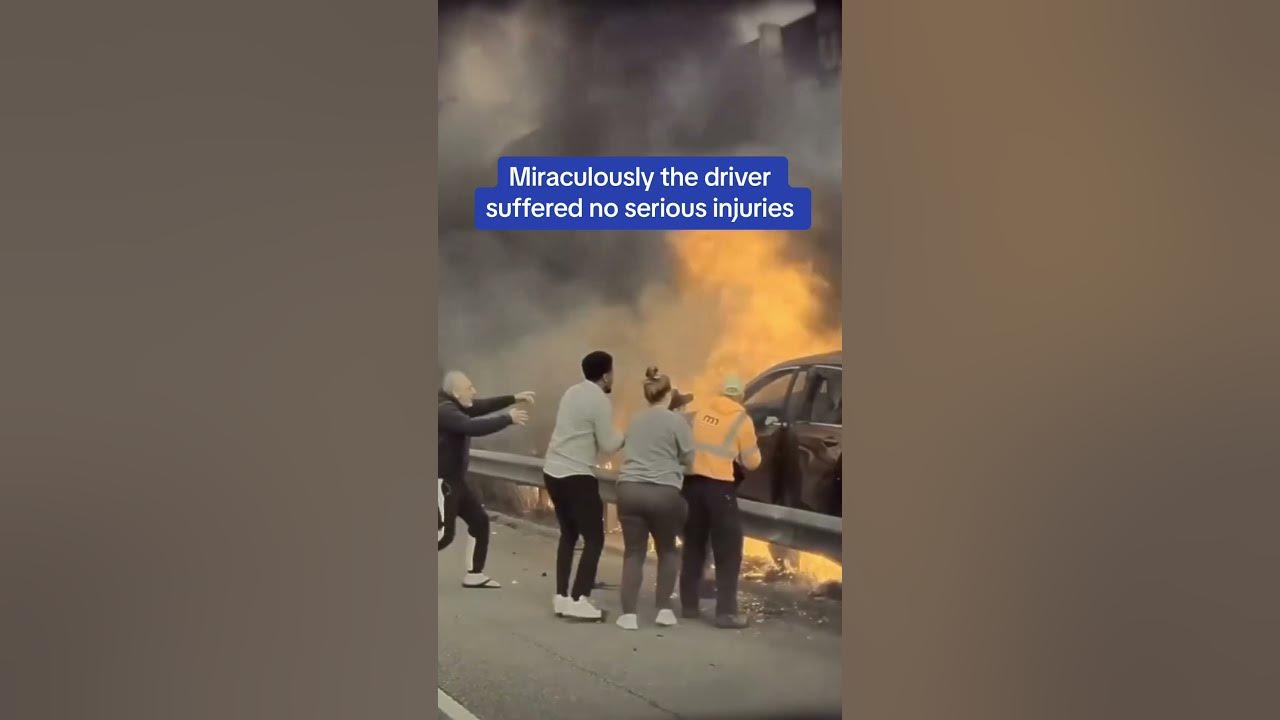 Terrifying moment a man is saved from a burning car