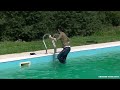 Girl swims fully clothed in public pool.