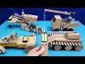 Homemade cardboard crane, tractor, motorbike, and tracked vehicle toys.