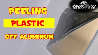Peeling plastic off of sheets of aluminum
