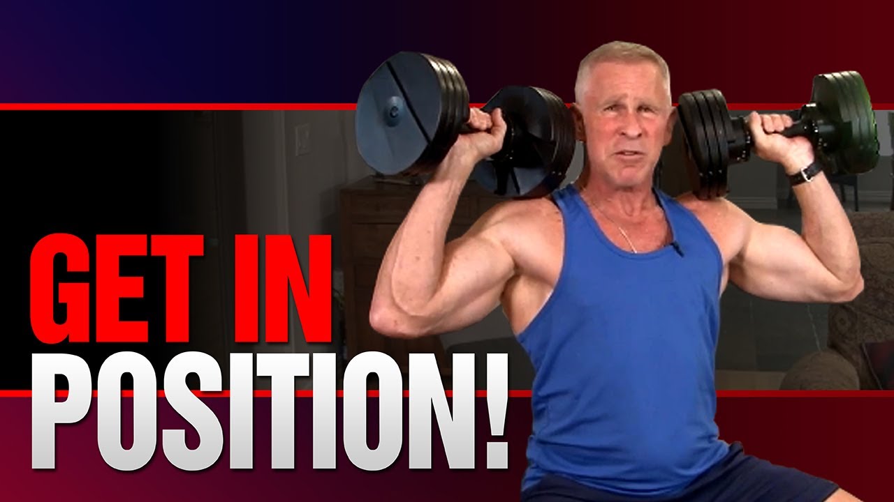 Premium Photo | Muscular man poses with heavy dumbbell on training in gym