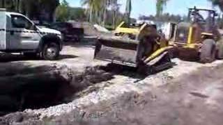 John Deere Loader pulling ASV RC100 out of the mud