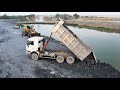 Heavy Loading Dump Trucks Transporting The Rock to Land Filling Deep Water &amp; Wheels Loader SDLG work