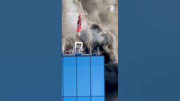 Man rescued from roof of burning high-rise by crane - ABC News