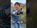 kid catch a tunna fish with fishing rod.