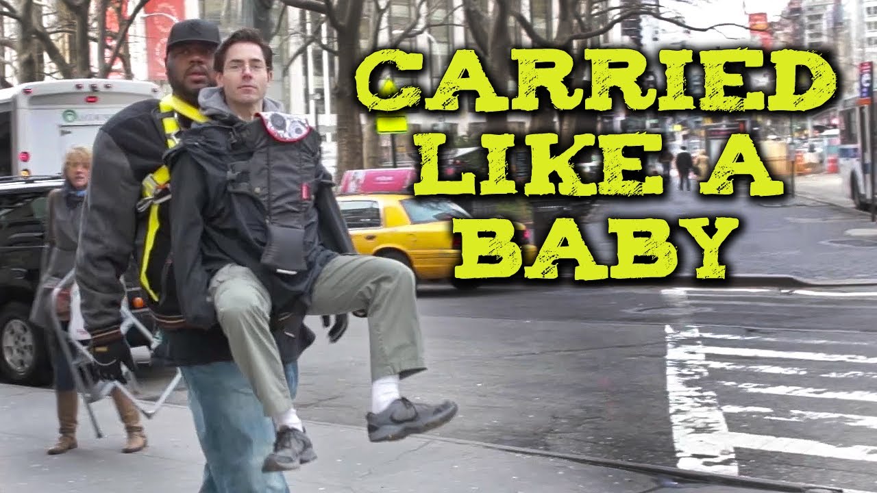 grown man in baby carrier