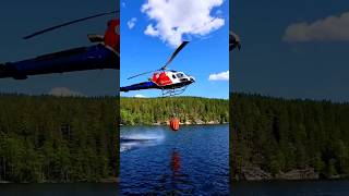 Dramatic Firefighting Operation: Helicopters Scooping Water from Lake to Battle Raging Wildfires