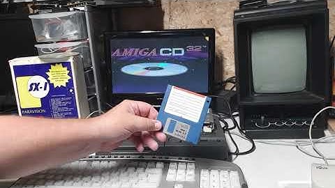 Amiga cd32 addon demonstration  also running action replay for trainers and ripping music