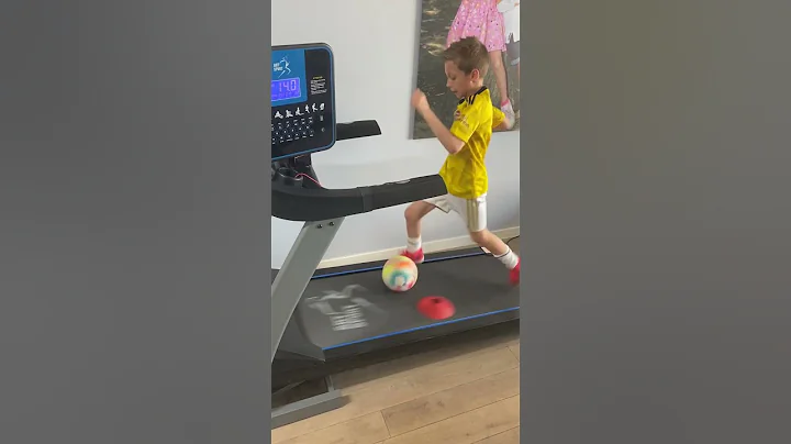 Skilled Boy Avoids Obstacles at High Speed on a Treadmill with a Football