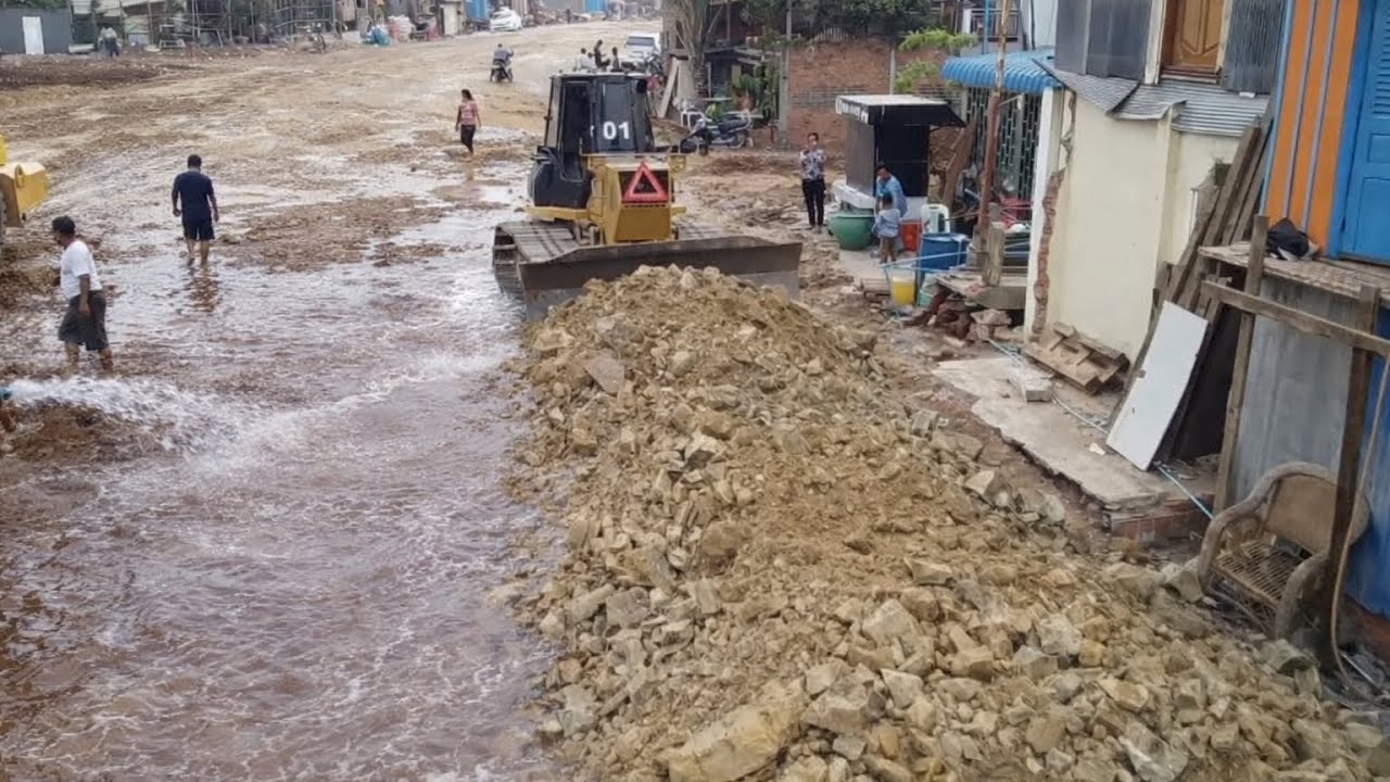 Komatsu Dozer Pushing Soil and Rock Repair An Old Road In Village