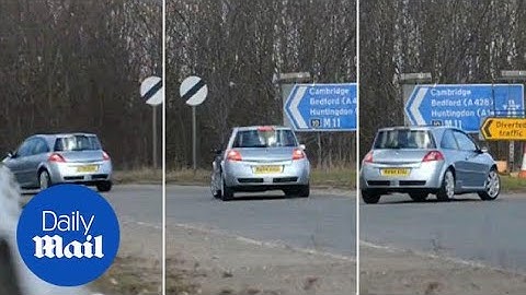Shocking moment string of cars reverse up motorway slip road - Daily Mail