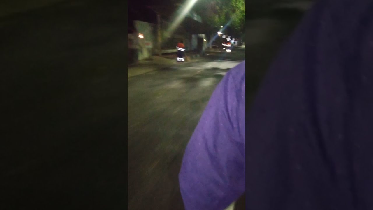 Biker Helping Girl On Road At Night 