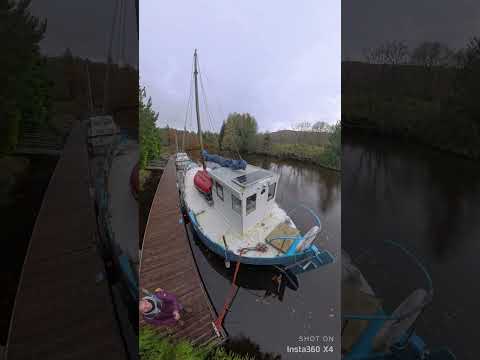 Boats moored on the Caledonian Canal at the far end of the cut beyond Laggan Locks
