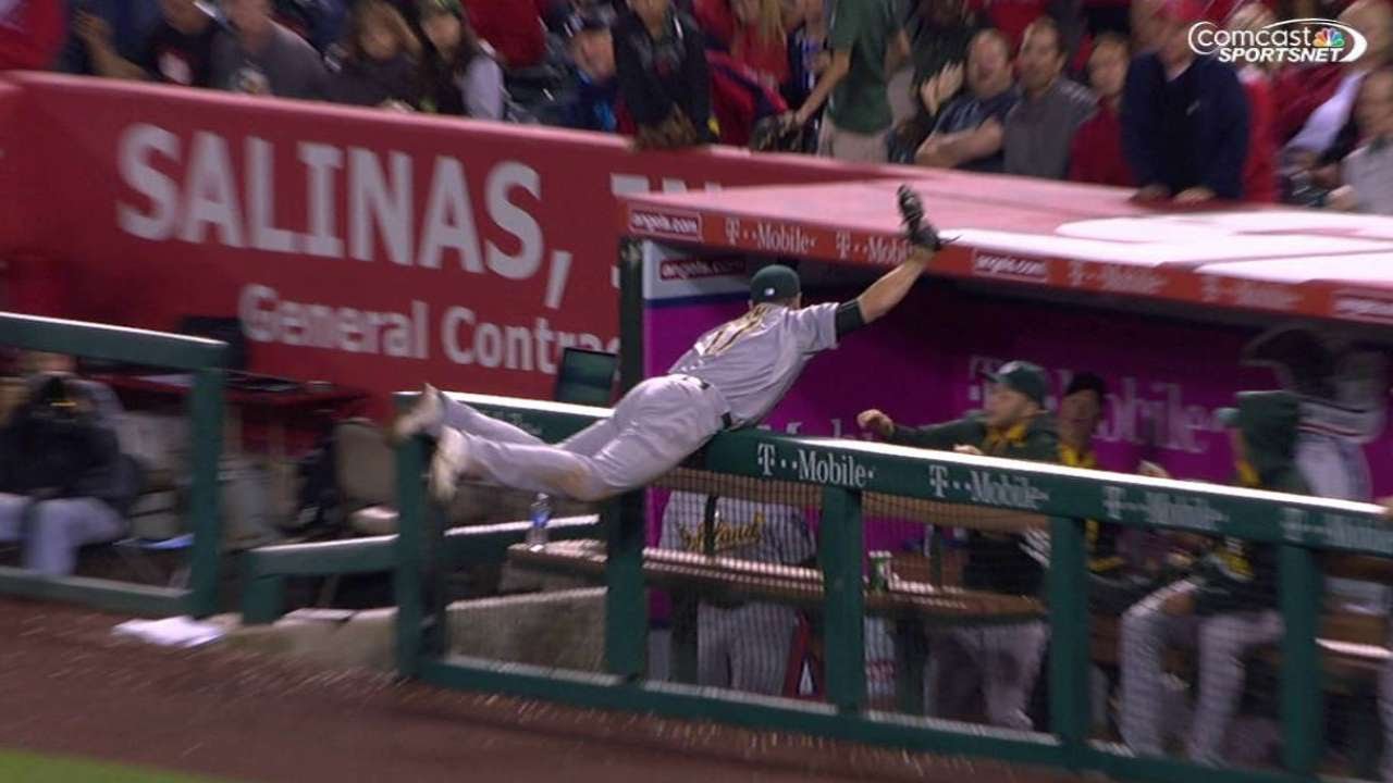 OAK@LAA: Davis leans over dugout railing to make grab - YouTube