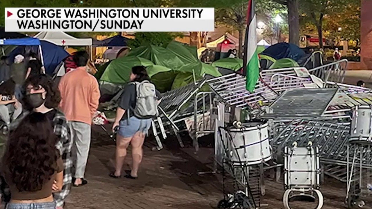 Protesters at George Washington University tear down police barriers