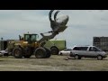 PAYLOADER DROPS ROCK ON VAN