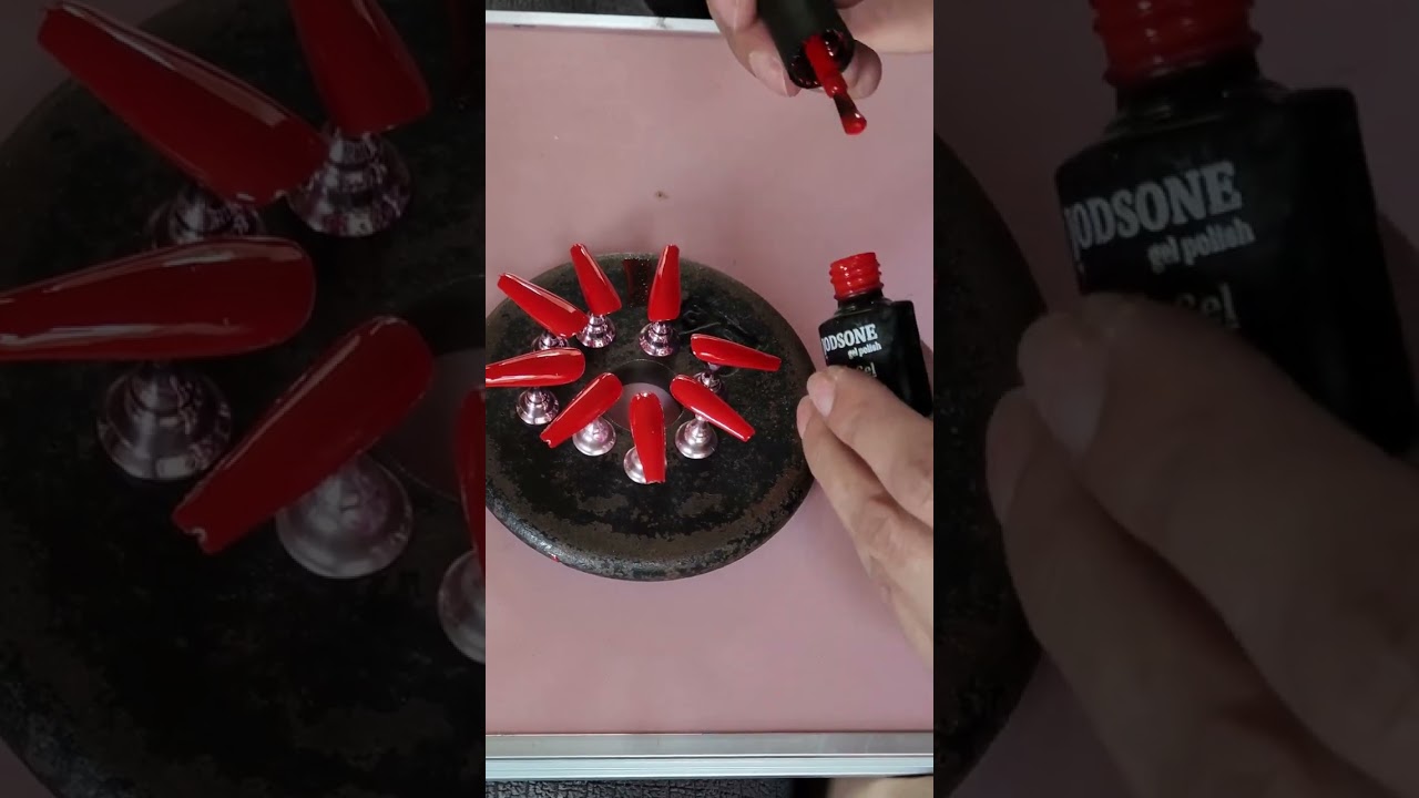Painting a set of press on nails red