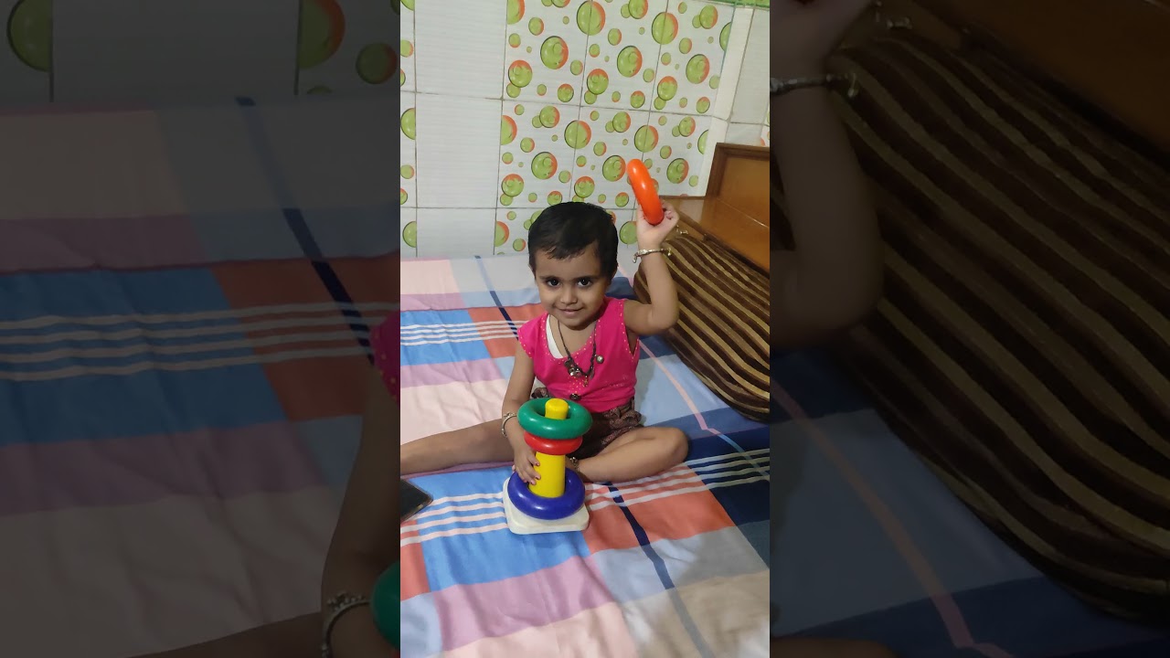 Little Angel Baby Playing with RIng Stack