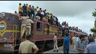 Passengers Trying To Ride Over The Top Of Engine But Rpf Police Preventing Them To Do So