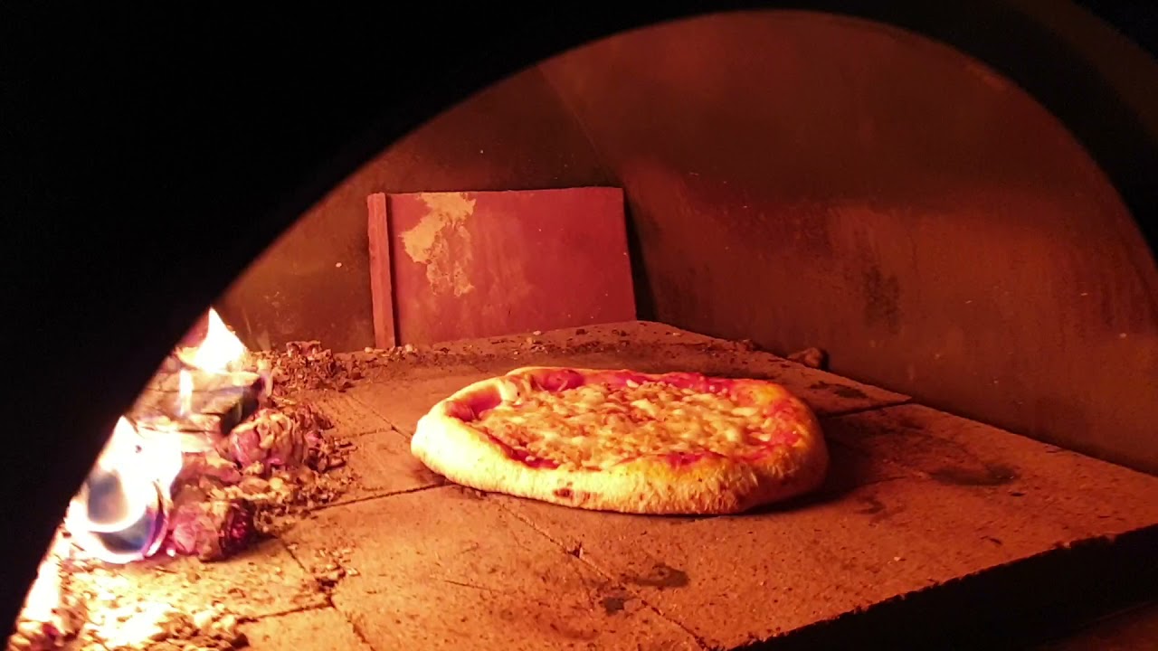 Pizza in my Aldi Fire King Roma wood oven - YouTube