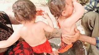 Washing the twins of a nomadic family by parents #Rural_family #villagelife @RAZ1499