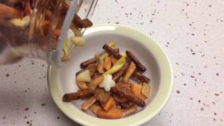 Snack mix being poured into a bowl - 240 fps slow motion - HD - Stock footage