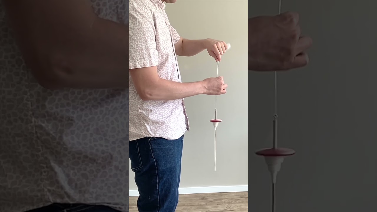 Spinning yarn with a whorl I made out of air dry clay 