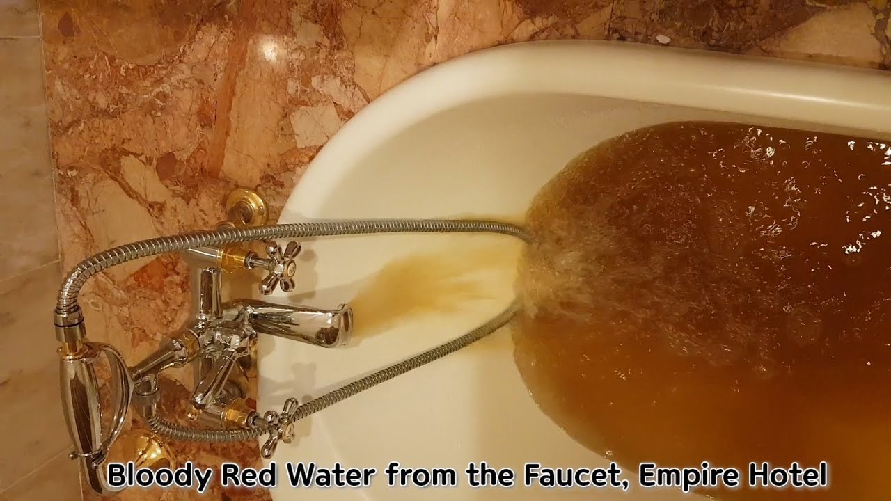 Red Water Pouring Out From The Water Faucet At Empire Hotel In