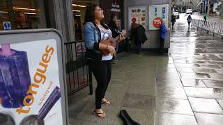 Busking girl in Aberdeen, Scotland Busking girl in Aberdeen, Scotland