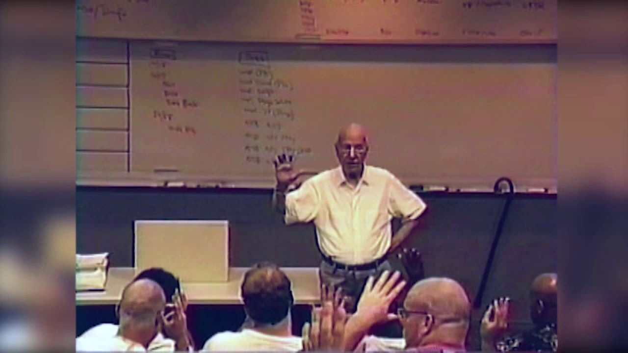 William D. Revelli Teaching Michigan Football Team to Sing "The Victors"