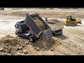 Nice job  dump truck t5 unloading soil delete mud landfilling using bulldozer komatsu d61p pushing