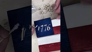 Glueing stars and numbers on a small flag. Luckily the glue dries clear!