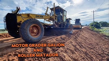 Motor Grader and Big Roller Grading and Compacting Along the High Slope of Embankment 