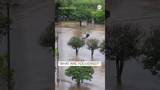 Texas driver gets stuck in floodwater as onlookers scream