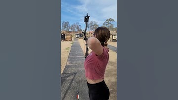 PERFECT archery shot with her compound bow and arrow