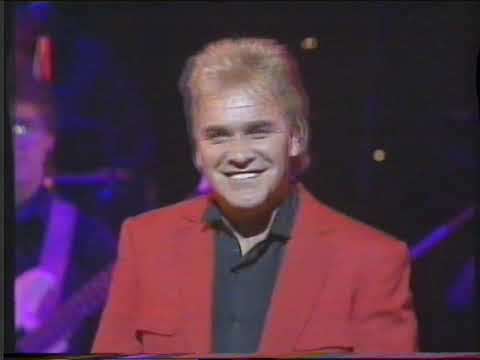 Kevin McMillan playing keyboard with Freddie Starr at the Royal Command Performance in 1989