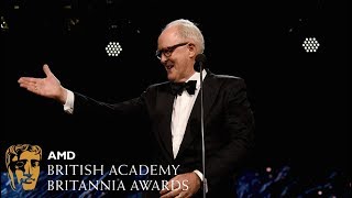 John Lithgow presents to Claire Foy at the Britannia Awards