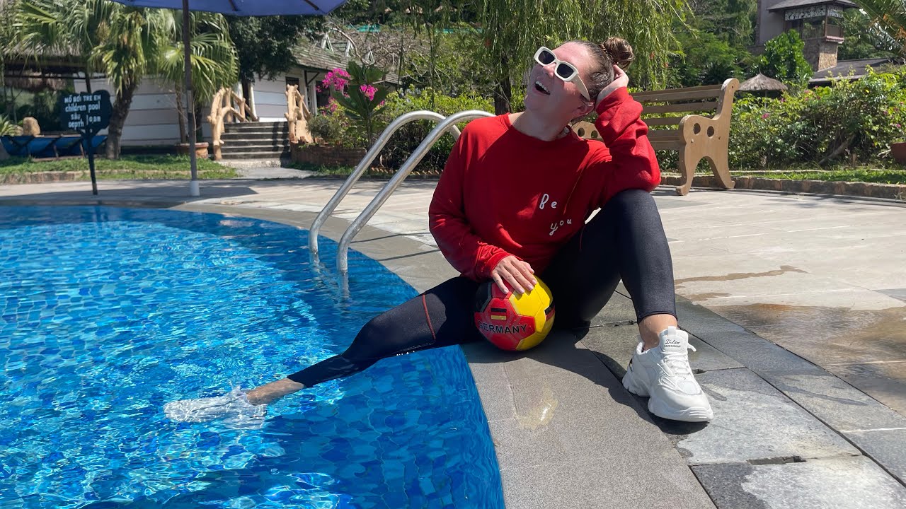 Red sweatshirt, leggings, sneakers.  Video in the pool and underwater.
