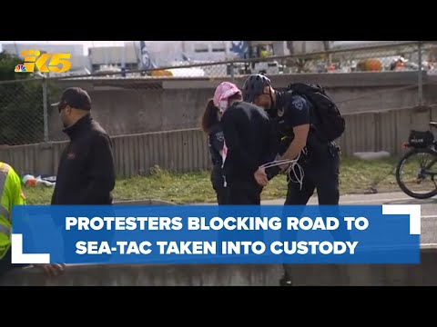 Protesters blocking road to Sea-Tac Airport being taken into custody