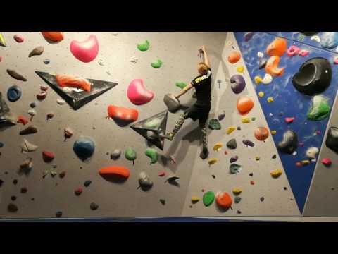 Climbing a 6b+ boulder problem (dyno)