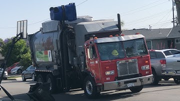 A revving Ware disposal Peterbilt 320 Hx-450 Amrep elliptical ASL helping on recyclables