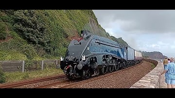 Sir Nigel Gresley 60007 steam train passing along Teignmouth sea wall